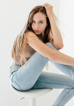 Studio portrait of blonde woman in skinny jeans