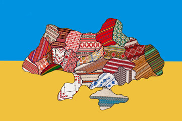 Stop war in Ukraine. Map of Ukraine with regions represented by their ethnic embroideries on the background of the state flag.