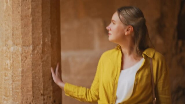 Woman visiting Tombs of the Kings in Paphos.