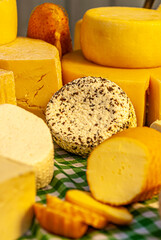 Different types of cheeses displayed on a typical Italian table, with special cutters for each type of cheese
