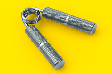 Iron hand expander or resistance band isolated on yellow background.