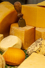 Different types of cheeses displayed on a typical Italian table, with special cutters for each type...