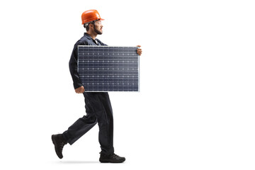 Male worker walking and carrying a solar panel