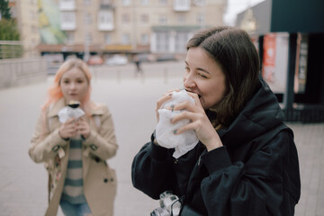 LGBT Lesbian couple eat sushi rolls on the walk asian cafe. street food