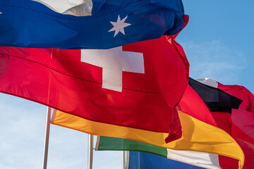 Flags of different countries waving in the sky