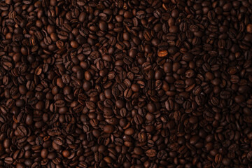 Many coffee beans spread out on a table