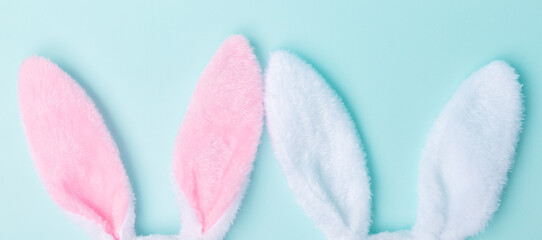 Toy bunny ears lie on the side on a blue background