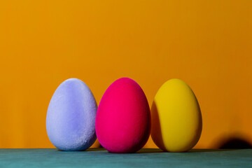 Three Soft Easter egg decoration on yellow background