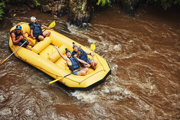 Life is either a daring adventure or nothing at all. Shot of a group of friends out river rafting on a sunny day.