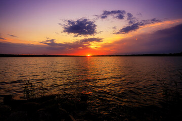 Sunrise on the river, before sunrise, with part of the shore and reeds