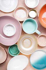 Ceramic tableware, crockery set on a beige background. Top view.