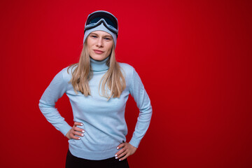 Portrait of a young woman in a sweater and ski goggles