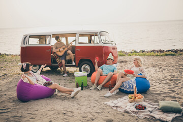Photo of funny subculture fellows enjoy chill journey abroad wear boho outfit nature seaside beach...