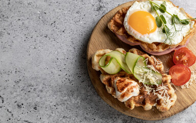 Breakfast with unsweetened croffles (Croissant waffle), fried egg, ham and vegetables. Copy space.