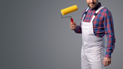 Professional painter posing with paint roller © StockPhotoPro