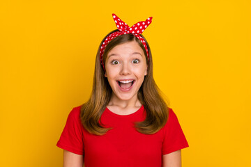 Photo of impressed teenager girl open mouth wear red t-shirt headband isolated on yellow color background