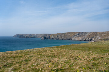 Cornwall coast with steep cliffs, beach and clear water in England, United Kingdom, beautiful hiking and biking trails for tourism and travel