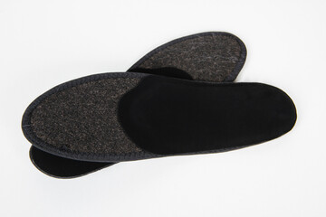 Black Insoles isolated on a white background. Medical orthopedic insoles. Foot care. Insole cutaway layers. Treatment and prevention of flat feet and foot diseases. Inner soles of shoes.