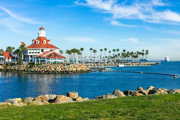 Fotobehang Shoreline Village in Rainbow Harbor In Long Beach, California. Shops line the edge of the marina area, and boats are docked in it's harbor. © Curioso.Photography