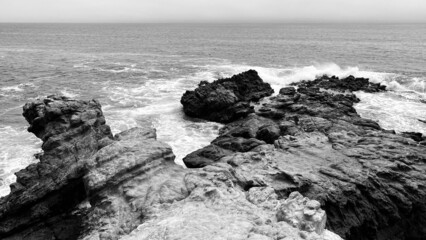 B&W Waves Against Rocks