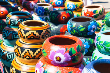 Variety of Colorfully Mexican Painted Ceramic Pots in an Outdoor Shopping Souvenir Market in Mexico.