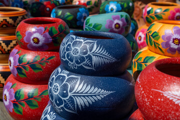 Fototapeta na wymiar Variety of Colorfully Mexican Painted Ceramic Pots in an Outdoor Shopping Souvenir Market in Mexico.