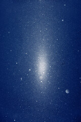 Fototapeta premium Snow and stars are falling on the background of blue luminous rays