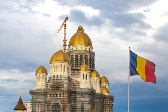 People's Salvation Cathedral, the biggest christian orthodox cathedral under construction in Bucharest, with Romanian flag waving in next to it. "Catedrala Mantuirii Neamului" in Romanian.