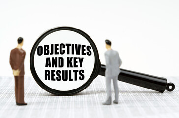 On the reports there are figures of people and a magnifying glass with the inscription - Objectives and Key Results