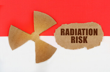 On the flag of Indonesia, the symbol of radioactivity and torn cardboard with the inscription -...