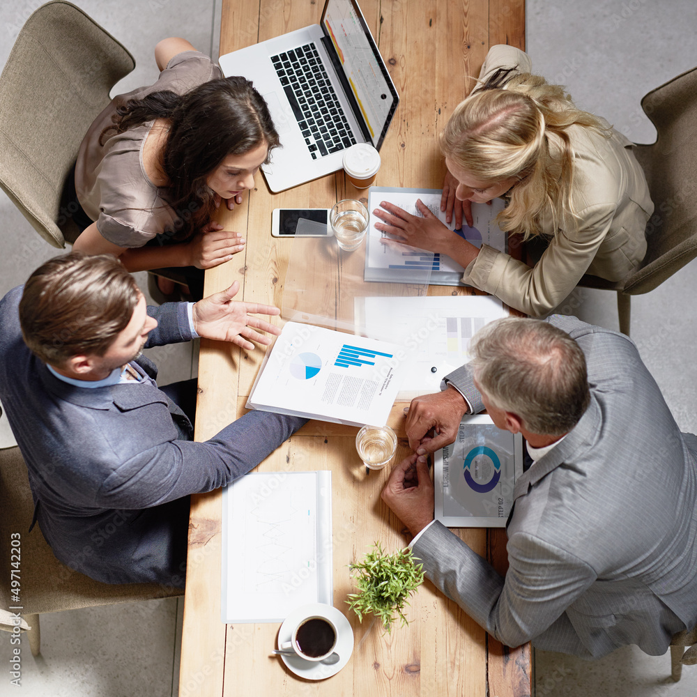 Poster looking through ways to build their business. high angle shot of a group of businesspeople having a 