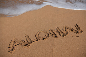 Aloha written in sand