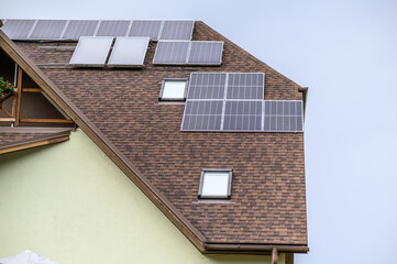 Obraz premium Solar panels on the roof of a private house. Ecological sources of energy.