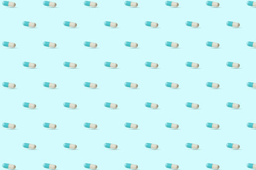 Seamless pattern with blue and white capsules, pills. Medical pharmacy flat lay design for presentation packaging website flyer cover business cards.