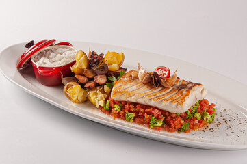 Cherne tranche with grilled octopus and potatoes on tomato tartare.