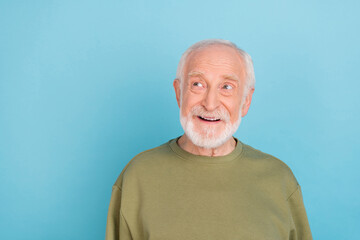 Portrait of attractive cheerful dreamy grey-haired man deciding copy space isolated over bright blue color background
