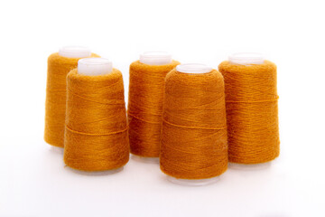 Orange spool of thread isolated on white background. Skein of woolen threads. Yarn for knitting....