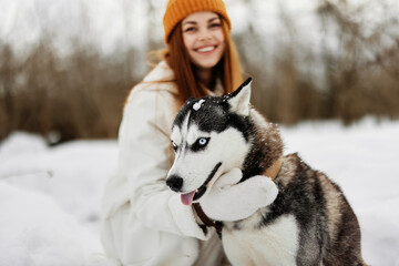 young woman with husky on the snow walk play rest fresh air