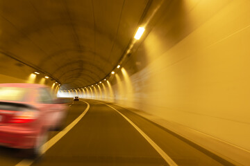 red car moving through a tunnel