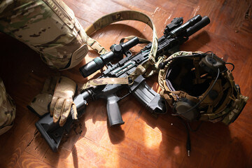 Close-up of machine gun and equipment on floor. Weapon, helmet and bullets lying on floor....