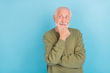 Portrait of attractive dreamy cheerful grey-haired man touching chin thinking copy space isolated...