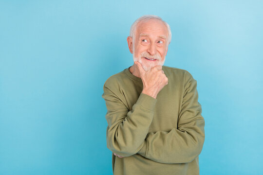 Portrait of attractive dreamy cheerful grey-haired man touching chin thinking copy space isolated over bright blue color background