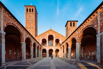 Fototapeta na wymiar Wide view of the Basilica of Sant'Ambrogio with a tourist in the center of the courtyard
