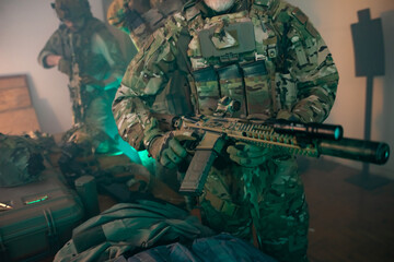 Fototapeta premium Cropped image of men in military equipment. Men in uniforms holding machine gun. Military, army, airsoft concept