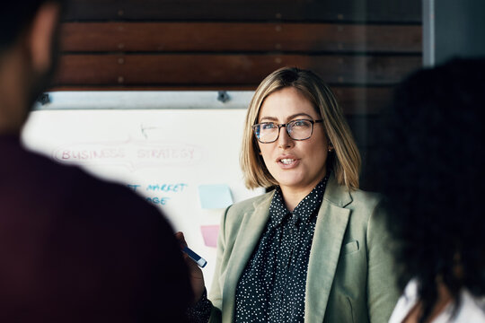 Find out and feedback. Shot of a group of colleagues having a brainstorming session in a modern office.