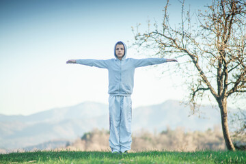 preparing for a sports competition, a young man performing exercises outdoor
