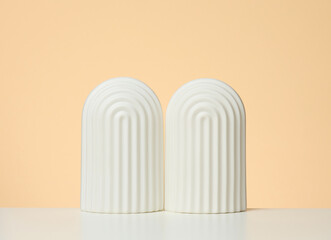 podium with white arches to showcase cosmetics, products and other goods, beige background