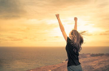 Strong confident woman with fist up to the sky. People feeling inspire, and having inner strength concept.	