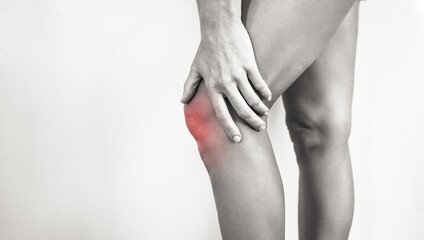 woman suffering from sprained sore knee  - obrazy, fototapety, plakaty