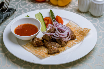 Kebab of veal with red onion and tomato sause
